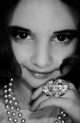 a black and white photo of a girl wearing a ring