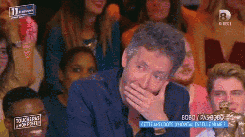 a man covering his mouth with his hand while watching a show called touche pas mon poste