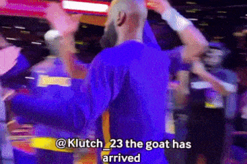 a man in a purple shirt with the words " klutch 23 the goat has arrived " written on the bottom