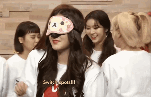 a girl wearing a sleep mask with the words switch spots written on it