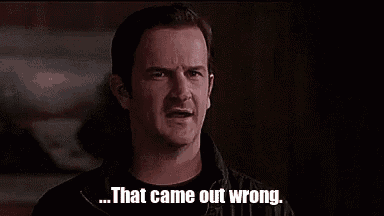 a man is standing in a dark room with the words `` that came out wrong '' written on the screen .