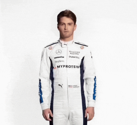 a man in a williams racing uniform is juggling tomatoes