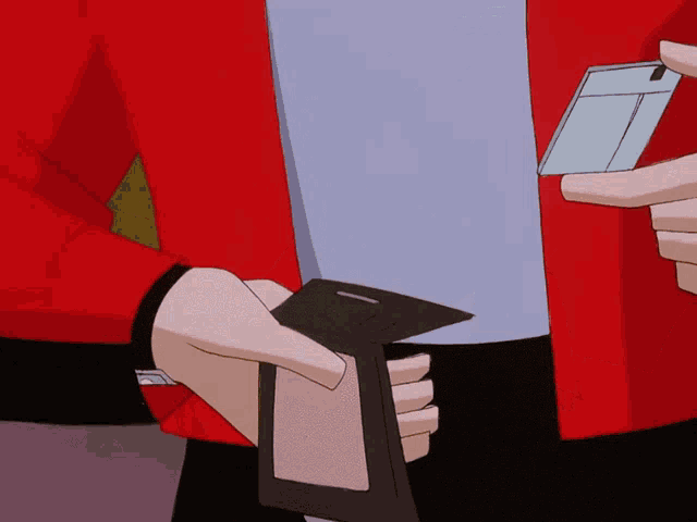 a person in a red jacket is holding a card in their hand
