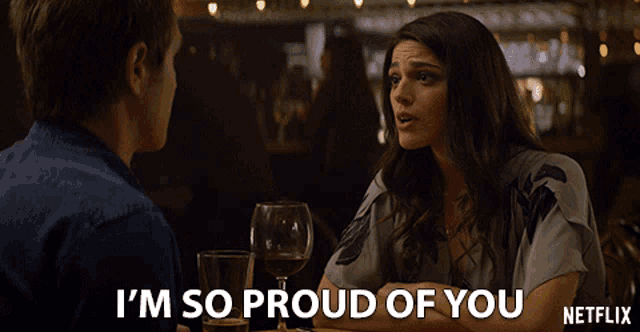 a man and a woman are sitting at a table and the woman says i 'm so proud of you netflix