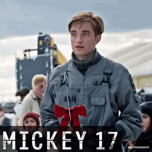 a man in a military uniform is standing in front of a sign that says " mickey 17 "