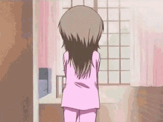 a girl in a pink pajama is standing in front of a window .