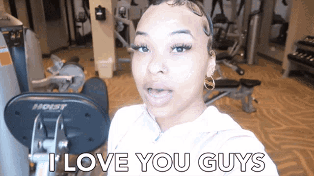 a woman says " i love you guys " while standing in a gym