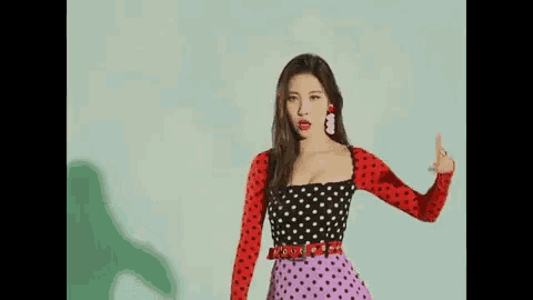 a woman in a polka dot dress is dancing with blood coming out of her mouth .