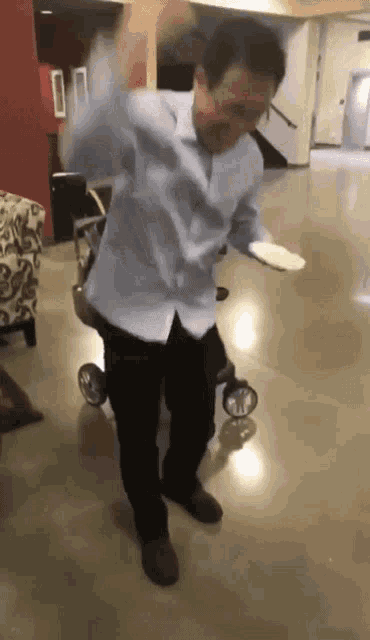 a man in a wheelchair is dancing with a plate