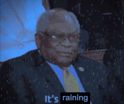 a man in a suit and tie is sitting under an umbrella with the words it 's raining above him
