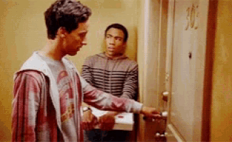 two men are standing in front of a door that says 305