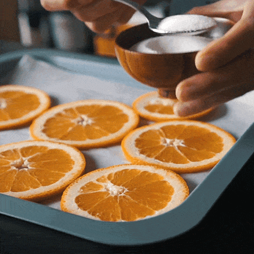 Adding Sugar On Top Of Sliced Orange Two Plaid Aprons GIF - Adding Sugar On Top Of Sliced Orange Two Plaid Aprons Sprinkle Sugar GIFs