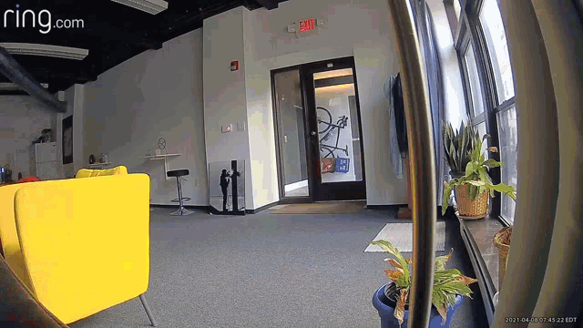 a ring.com camera shows a living room with a yellow couch