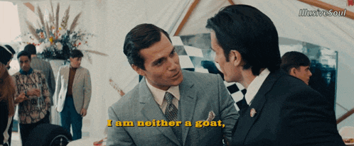 a man in a suit says " i am neither a goat " while talking to another man