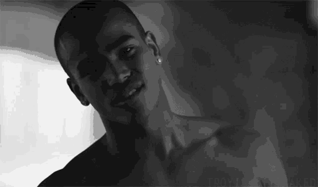 a black and white photo of a shirtless man with the word naked on the bottom