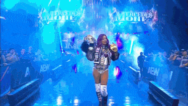 a female wrestler is walking down a hallway with the words mercedes mode on the wall behind her