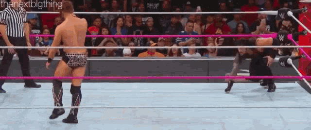 two men are wrestling in a ring with a referee in the background and the words " the nextbigthing " on the bottom