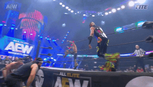 a wrestler in a ring with a sign that says all elite aew