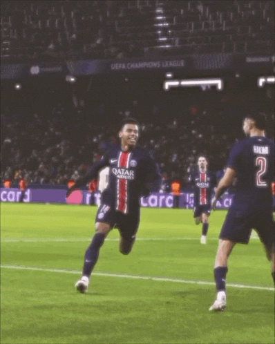 a soccer player wearing a qatar jersey celebrates his goal