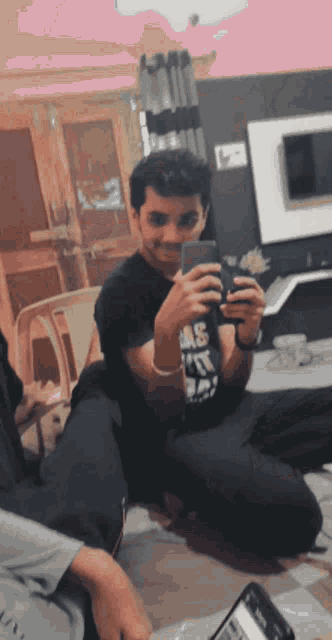 a man is taking a picture of himself with a cell phone