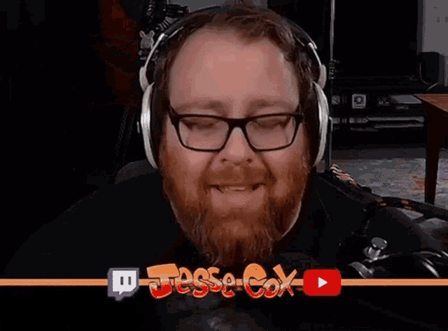 a man wearing glasses and headphones is laughing in front of a banner that says jesse-cox