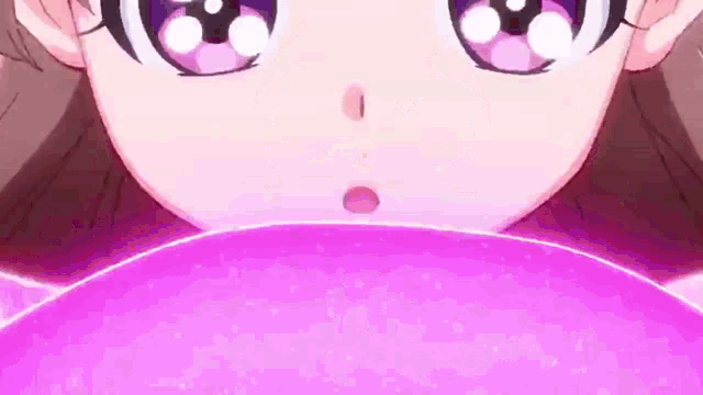 a close up of a girl 's face with a pink balloon in her hand .