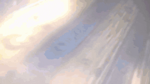 the sun shines through the clouds on a gray background