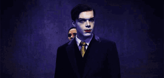 a man in a suit and tie with red lips stands next to a woman