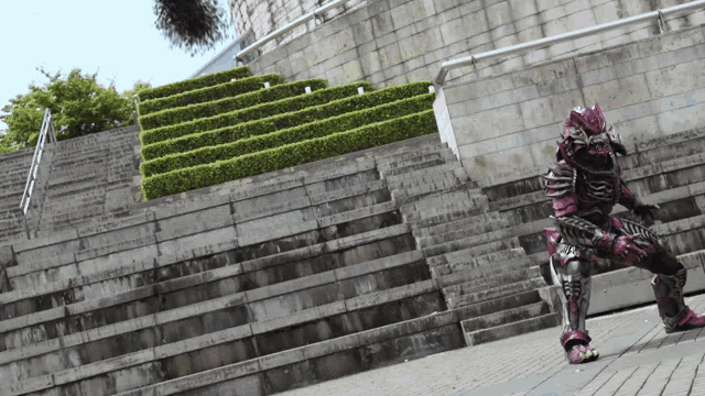 a person in a purple and black costume stands in front of a stone wall