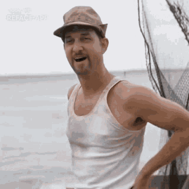 a man wearing a hat and a tank top is standing on a boat in the water .