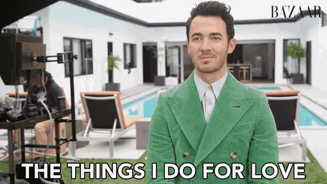 a man in a green jacket with the words the things i do for love behind him