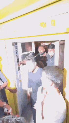 a group of people are standing in a room with the word filmgyan on the bottom right