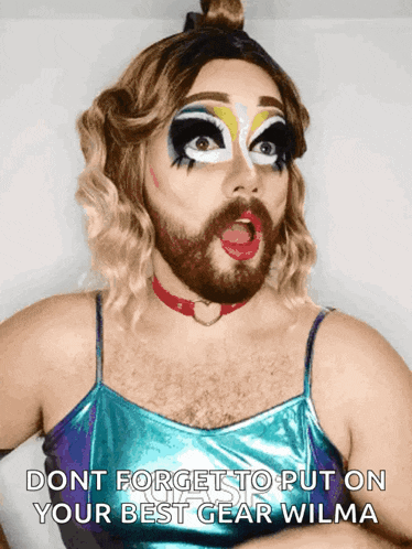 a drag queen says do n't forget to put on your best gear wilma while making a surprised face