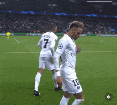 a soccer player with the number 10 on his jersey stands on the field