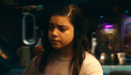 a close up of a girl 's face in a dark room