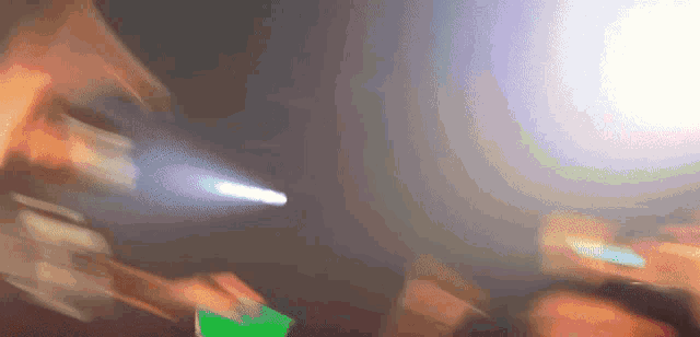 a blurry picture of a person holding a green card