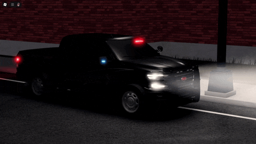 a gmc truck is parked on the side of the road in the dark