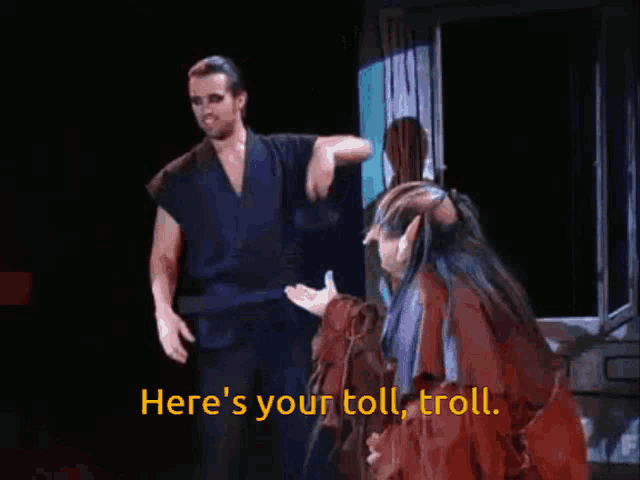 a man and a woman on a stage with the words here 's your toll troll on the bottom