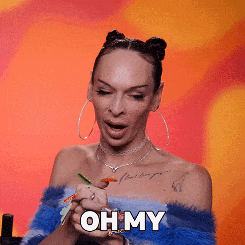 a woman with colorful nails is holding her hands together and says oh my