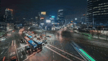 a busy city intersection at night with a sign that says ' a ' on it