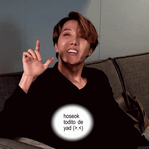 a man sitting on a couch with a circle around his head that says hoseok todito de yad