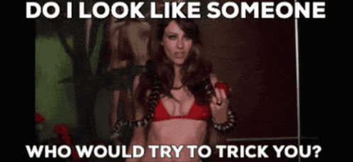 a woman in a red bikini with a snake around her neck says do i look like someone who would trick you