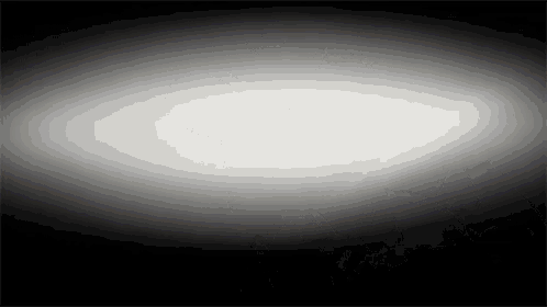 a white light is shining through a black background .