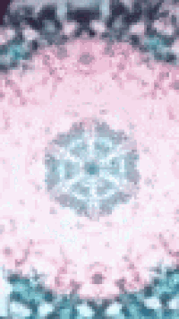 a close up of a pink and blue kaleidoscope with a snowflake in the middle .