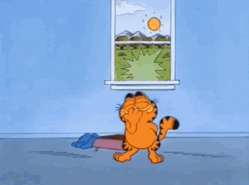 garfield the cat is sitting on the floor next to a pink box .