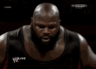 a man in a boxing ring with the words w live on the bottom right