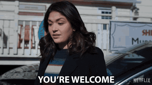 a woman says you 're welcome in front of a netflix logo