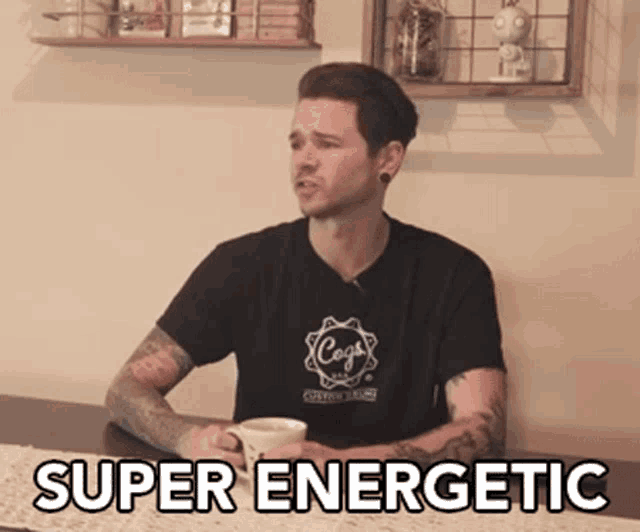 a man is sitting at a table with a cup of coffee and the words super energetic written on the table