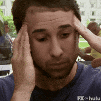 a man is holding his head while wearing a blue shirt from fx on hulu
