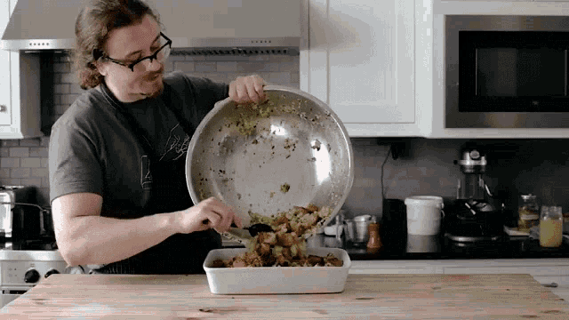 a man is pouring food into a casserole dish with a spoon